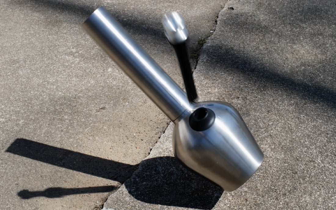Stainless steel smoking device on pavement
