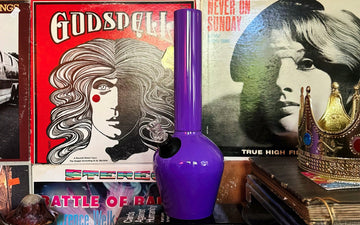 Purple bong beside vintage vinyl records
