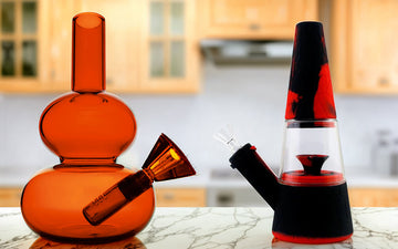 Glass bong and silicone bong on marble countertop in kitchen