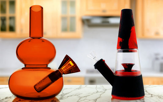 Glass bong and silicone bong on marble countertop in kitchen