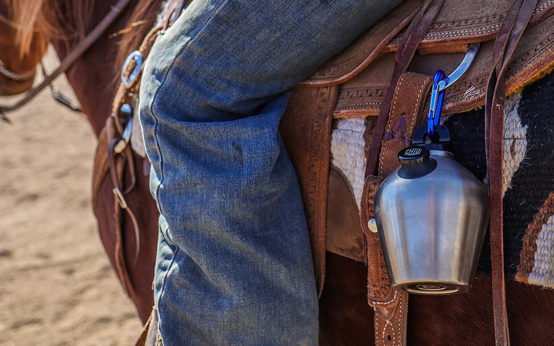 Cowboy gear with water bottle on saddle