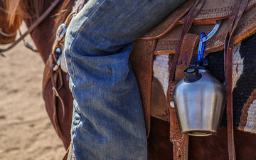 Cowboy gear with water bottle on saddle