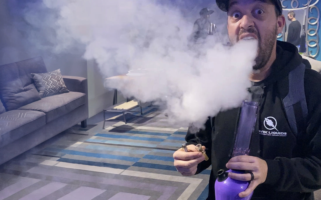 Man exhaling smoke from bong