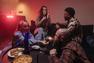 Group of friends smoking and socializing indoors