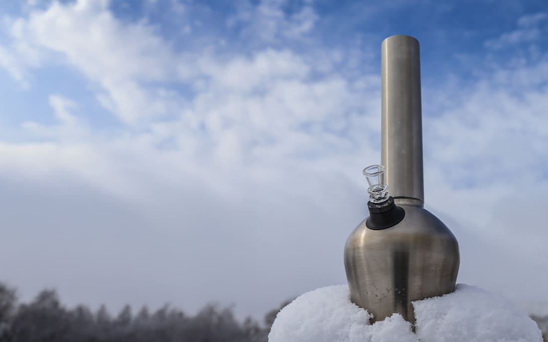 Metallic outdoor bong on snowy surface