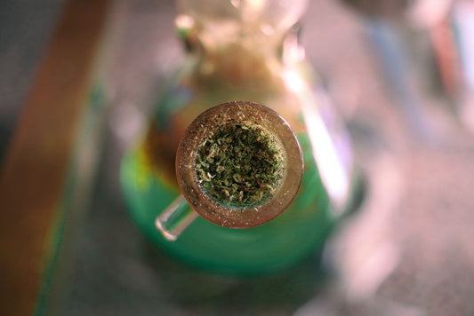 Ground herbs in a glass bong bowl