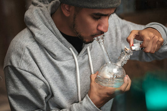 Person lighting a bong and inhaling