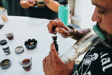 Person using a bong at a table