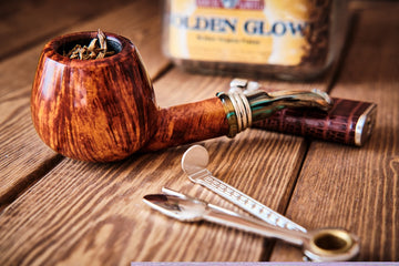 Wooden pipe and metal tools on table